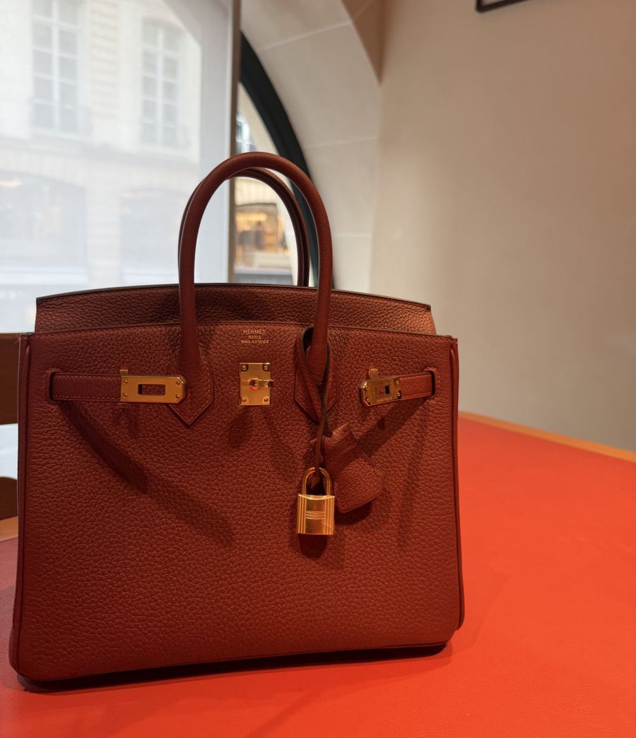 A burgundy Hermès Birkin with gold hardware