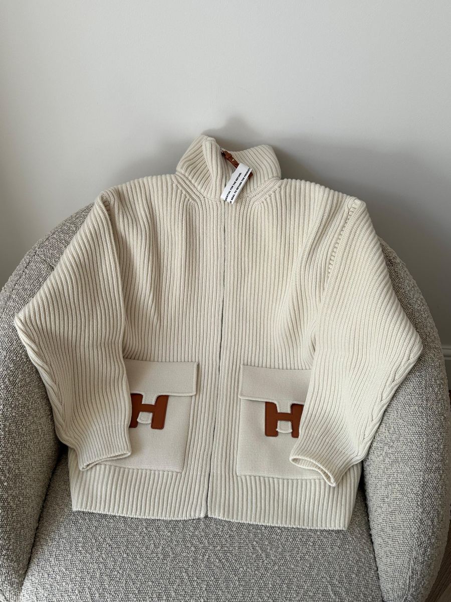 A cream Hermès knit cardigan with leather H pockets