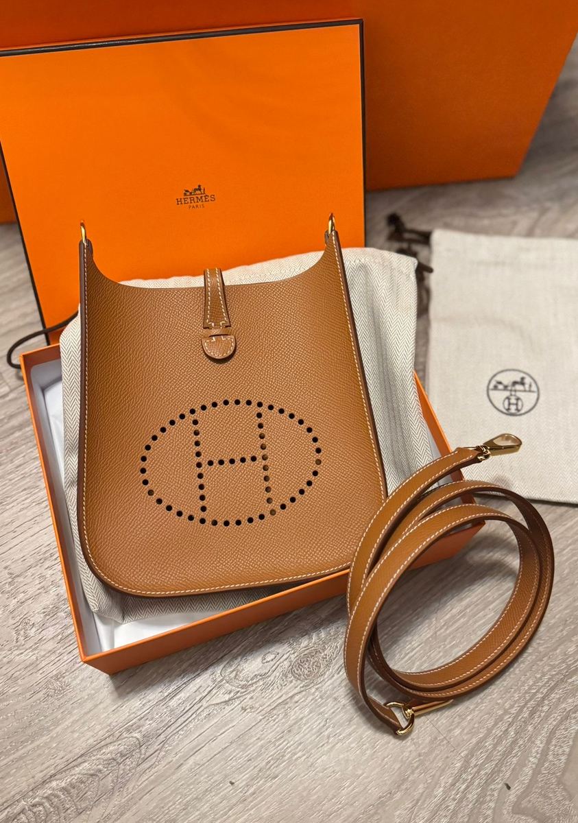 A tan Hermès Evelyne with its orange box